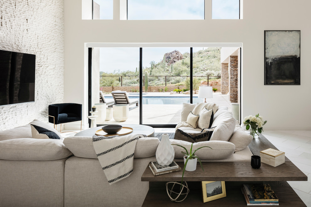 Inspiration for a large transitional open concept living room in Phoenix with white walls, porcelain floors, no fireplace, a wall-mounted tv and white floor.