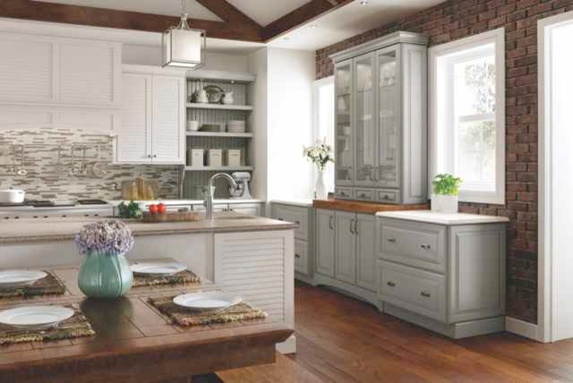Inspiration for a large beach style l-shaped separate kitchen in Cincinnati with with island, white cabinets, an undermount sink, louvered cabinets, marble benchtops, multi-coloured splashback, matchstick tile splashback, white appliances, dark hardwood floors and brown floor.