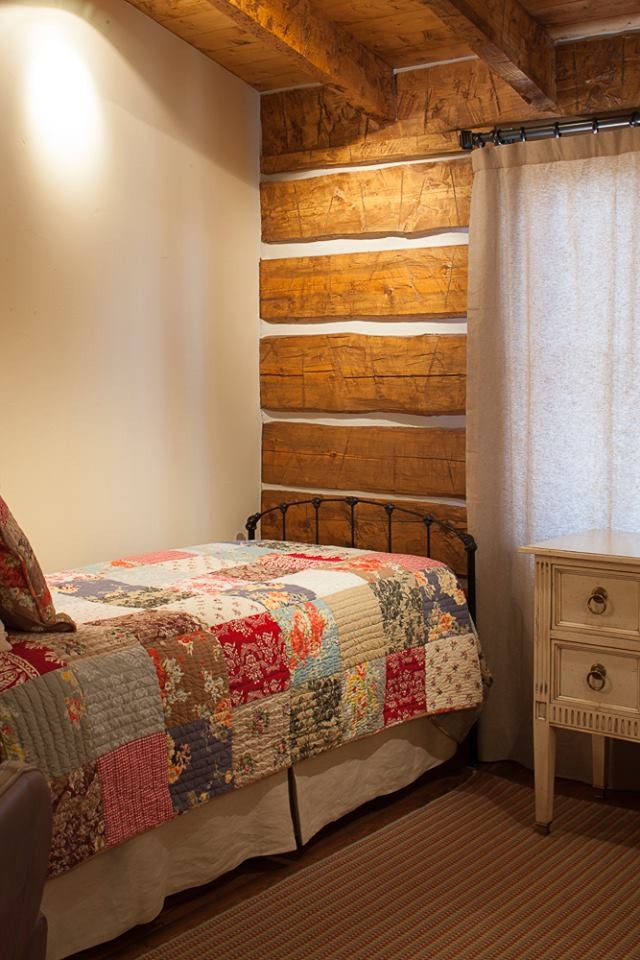 This is an example of a country bedroom in Other.