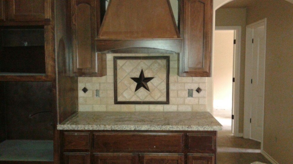 Eat-in kitchen - large rustic u-shaped ceramic tile eat-in kitchen idea in Austin with a drop-in sink, raised-panel cabinets, medium tone wood cabinets, granite countertops, multicolored backsplash, mosaic tile backsplash, stainless steel appliances and an island