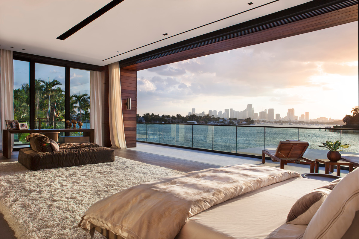 This is an example of a contemporary bedroom in Miami with dark hardwood floors and brown floor.