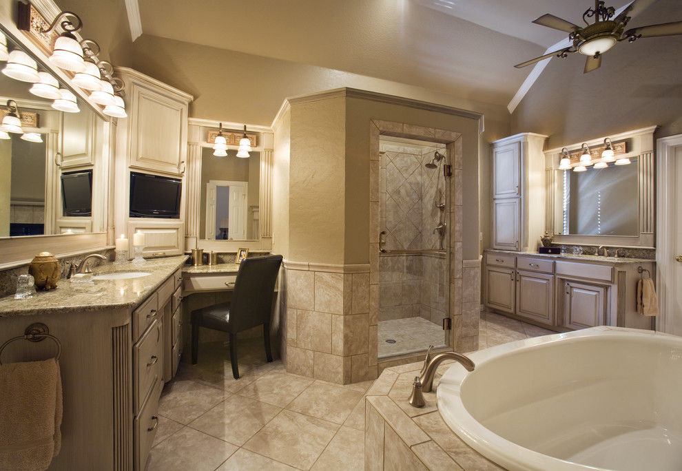 Inspiration for a large traditional master bathroom in Dallas with raised-panel cabinets, beige cabinets, a drop-in tub, an alcove shower, beige tile, porcelain tile, beige walls, porcelain floors, an undermount sink, granite benchtops, beige floor and a hinged shower door.