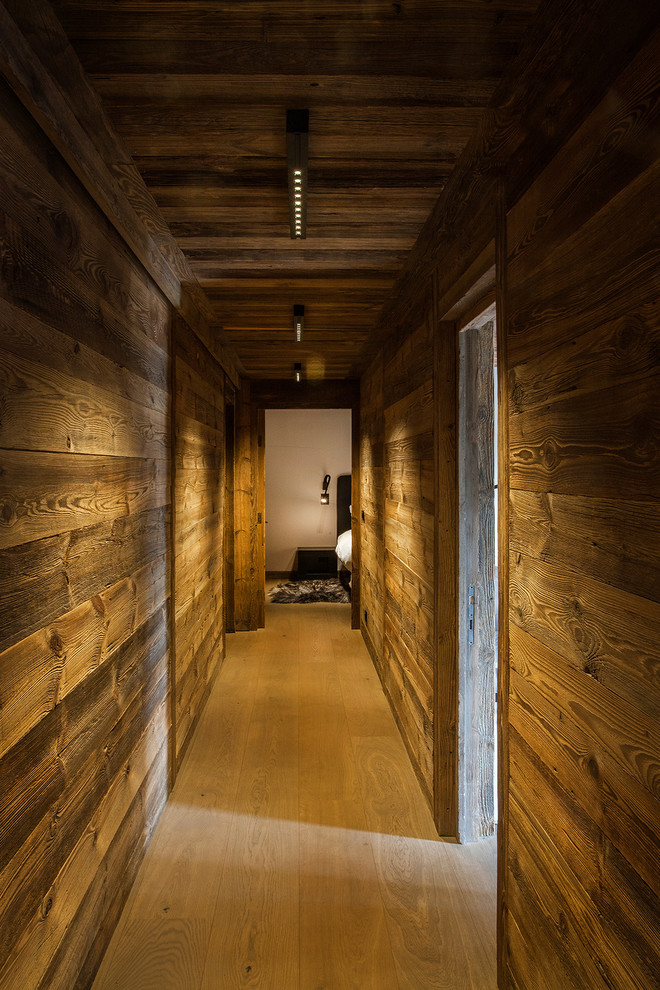 This is an example of a country hallway in Lyon with light hardwood floors.