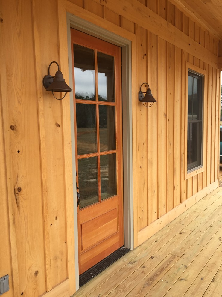Example of a mountain style one-story wood home design design with a metal roof
