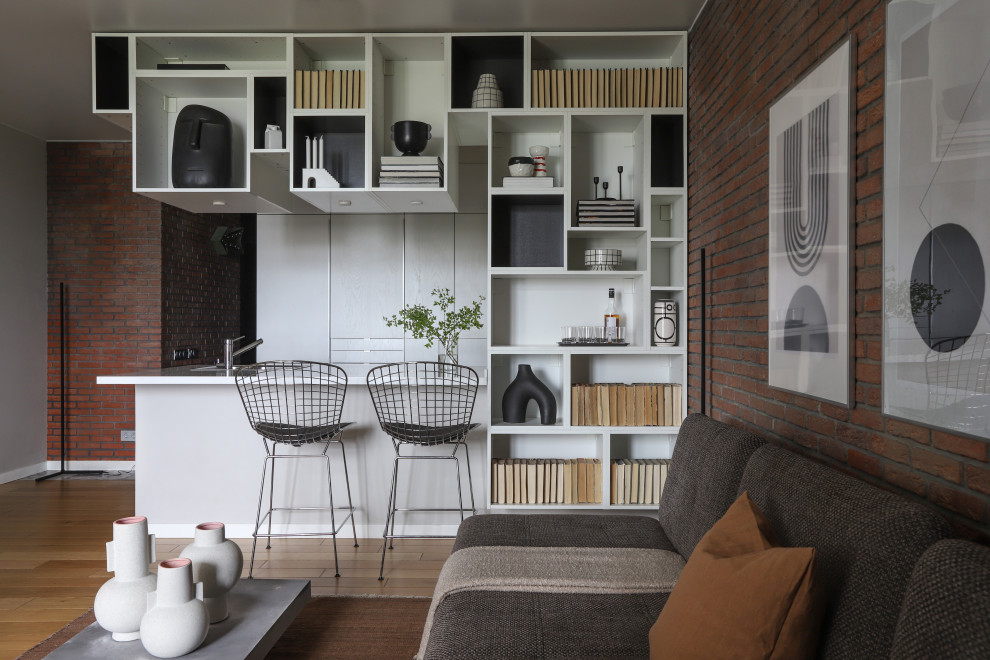 This is an example of a contemporary open concept living room in Saint Petersburg with brown walls, brown floor and brick walls.