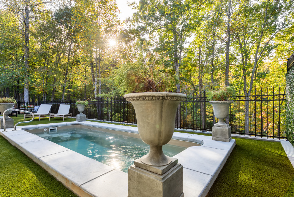 This is an example of a small transitional backyard rectangular lap pool in Other with concrete pavers.