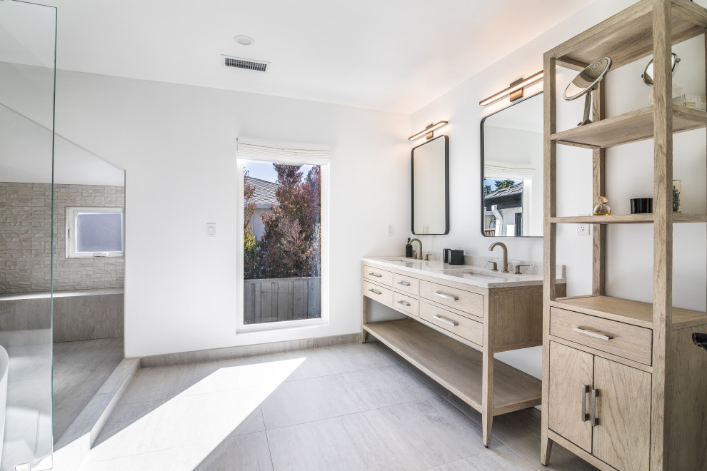 Example of a large minimalist master gray tile and porcelain tile porcelain tile, gray floor and double-sink bathroom design in San Francisco with light wood cabinets, a one-piece toilet, white walls, an undermount sink, quartz countertops, gray countertops and a freestanding vanity
