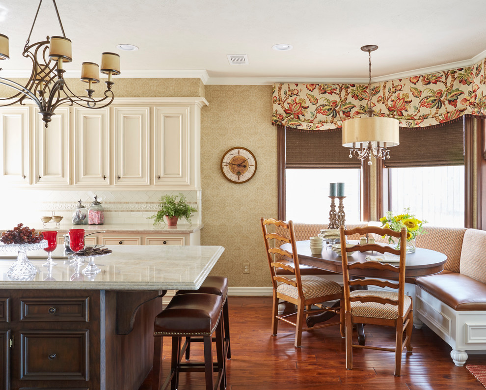 Inspiration for a traditional eat-in kitchen in Houston with recessed-panel cabinets, beige cabinets, white splashback, medium hardwood floors and with island.