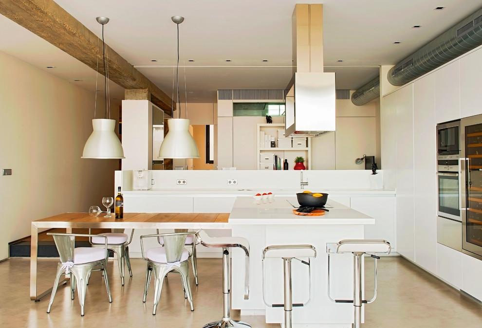 Inspiration for a large industrial single-wall open plan kitchen in Other with flat-panel cabinets, white cabinets, concrete floors, with island, white splashback and stainless steel appliances.
