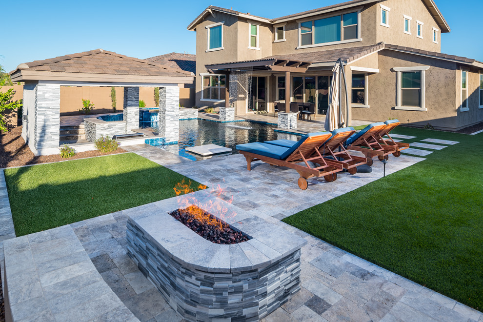 Design ideas for a mid-sized contemporary backyard patio in Phoenix with a water feature and tile.
