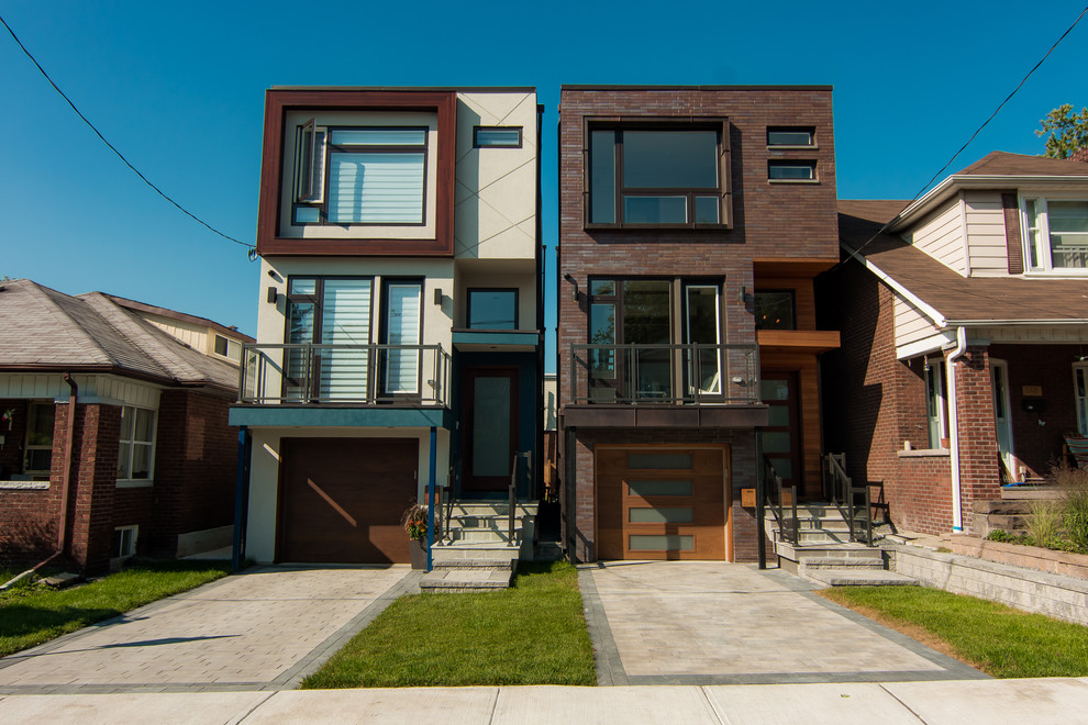 Inspiration for a mid-sized contemporary three-storey brick brown townhouse exterior in Toronto with a flat roof.