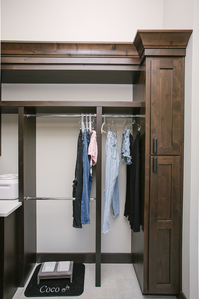 Mid-sized transitional galley dedicated laundry room in Portland with a farmhouse sink, shaker cabinets, dark wood cabinets, beige walls, ceramic floors, a side-by-side washer and dryer, beige floor and white benchtop.