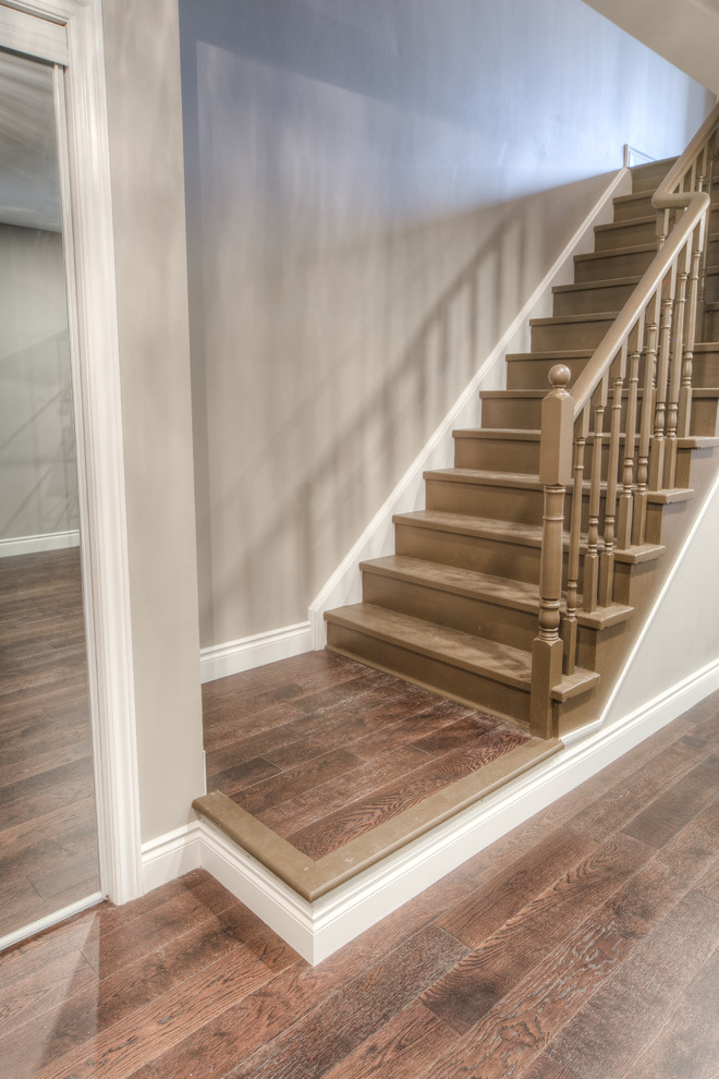 Mid-sized arts and crafts painted wood straight staircase in Toronto with painted wood risers and wood railing.