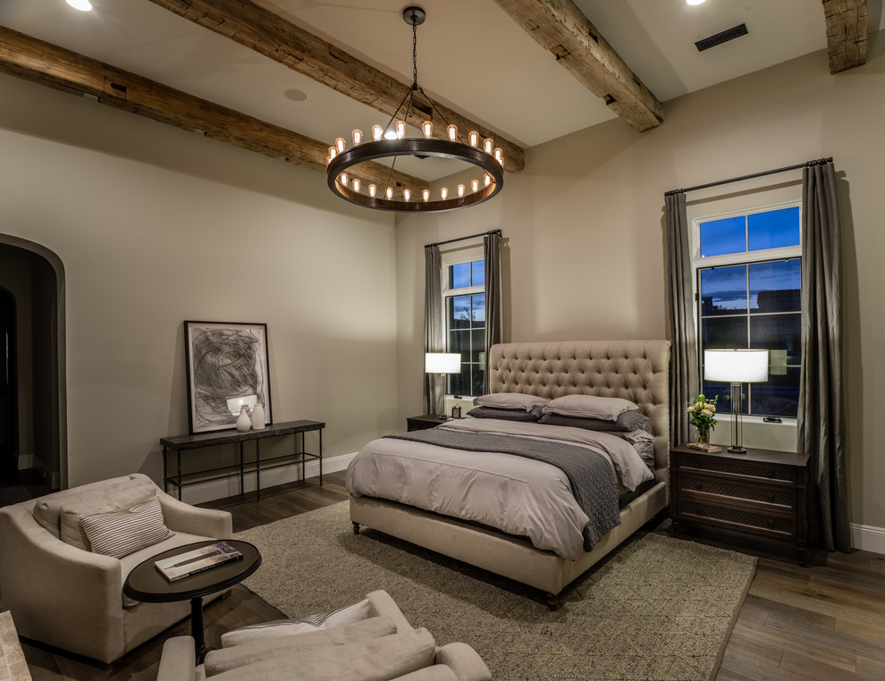 This is an example of a transitional master bedroom in Phoenix with beige walls and dark hardwood floors.
