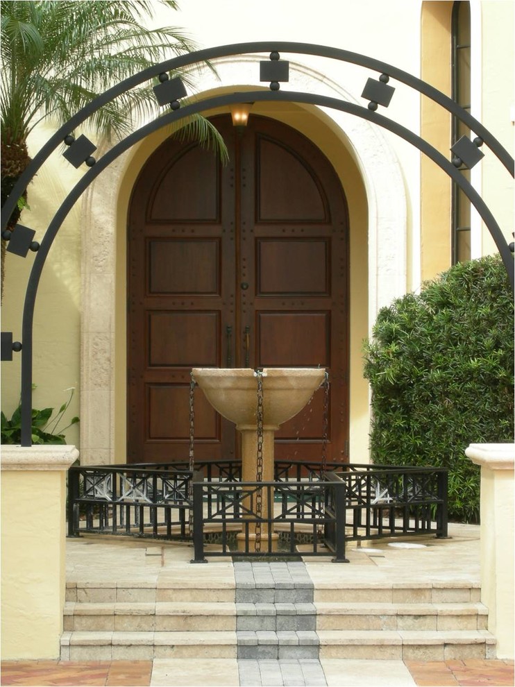 Photo of a large traditional front door in Miami with multi-coloured walls, limestone floors, a double front door and a medium wood front door.