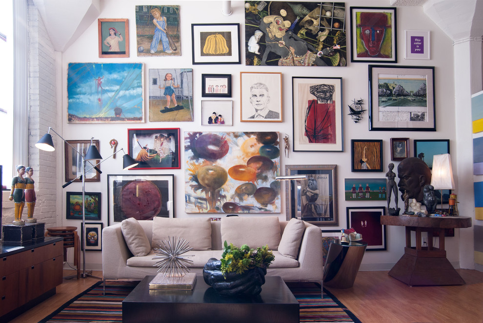 Eclectic living room in Other with white walls and medium hardwood floors.