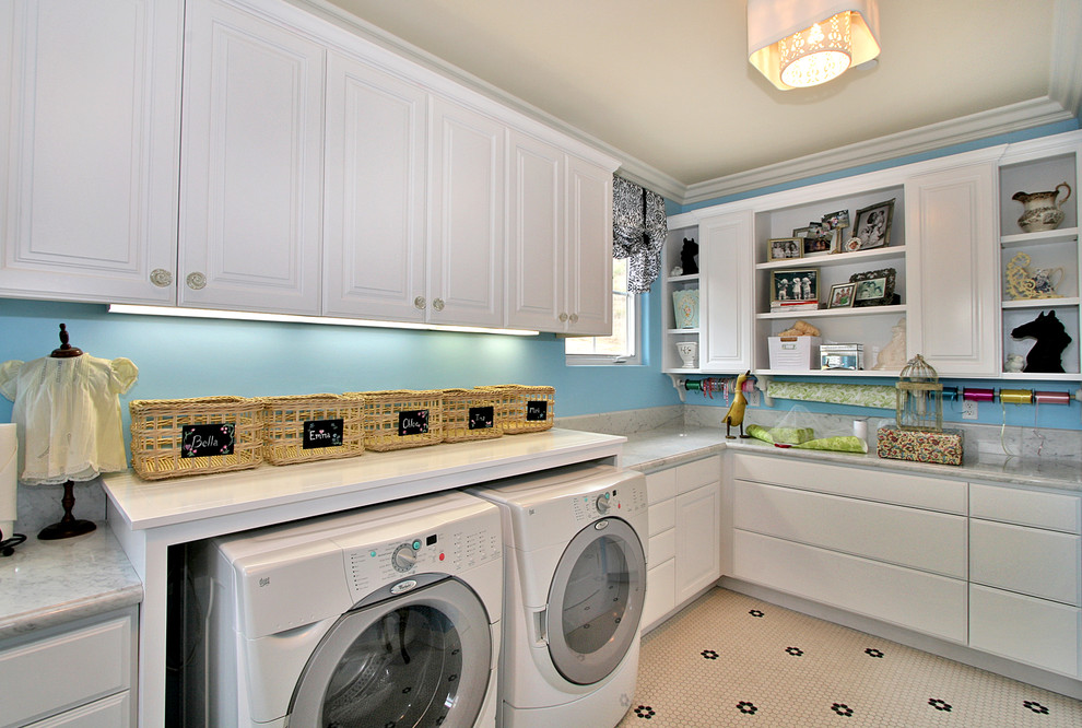 Inspiration for a contemporary laundry room in San Diego with white cabinets.