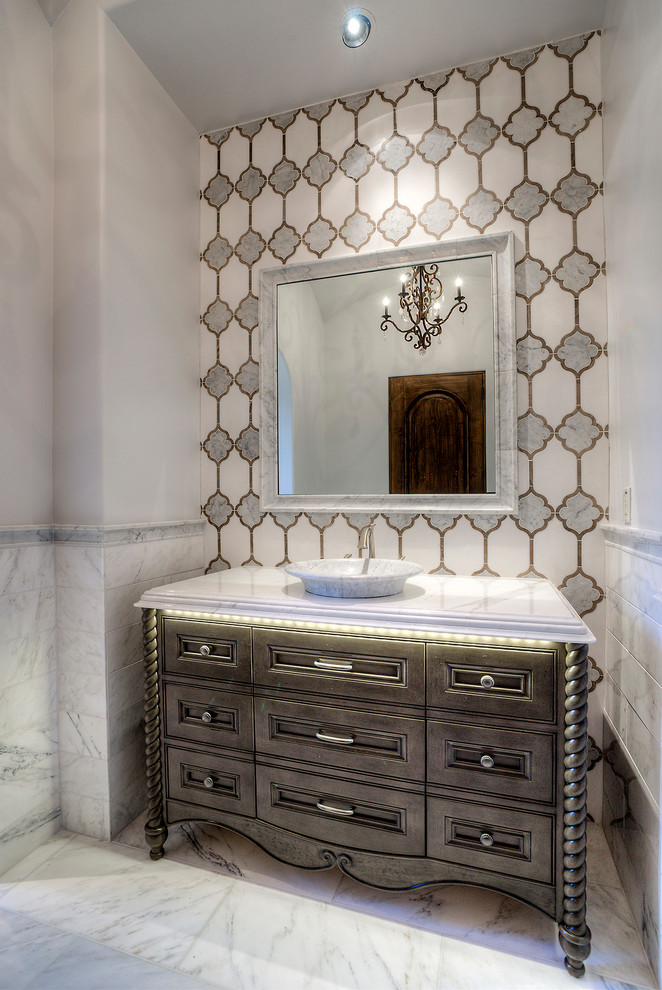This is an example of an expansive traditional 3/4 bathroom in Phoenix with white tile, marble floors, a vessel sink, marble benchtops, furniture-like cabinets, brown cabinets, stone tile and beige walls.