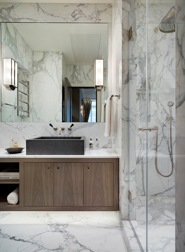 Photo of a mid-sized modern master bathroom in London with flat-panel cabinets, brown cabinets, an open shower, gray tile, white tile, marble, marble floors, a vessel sink, marble benchtops, white floor and a hinged shower door.