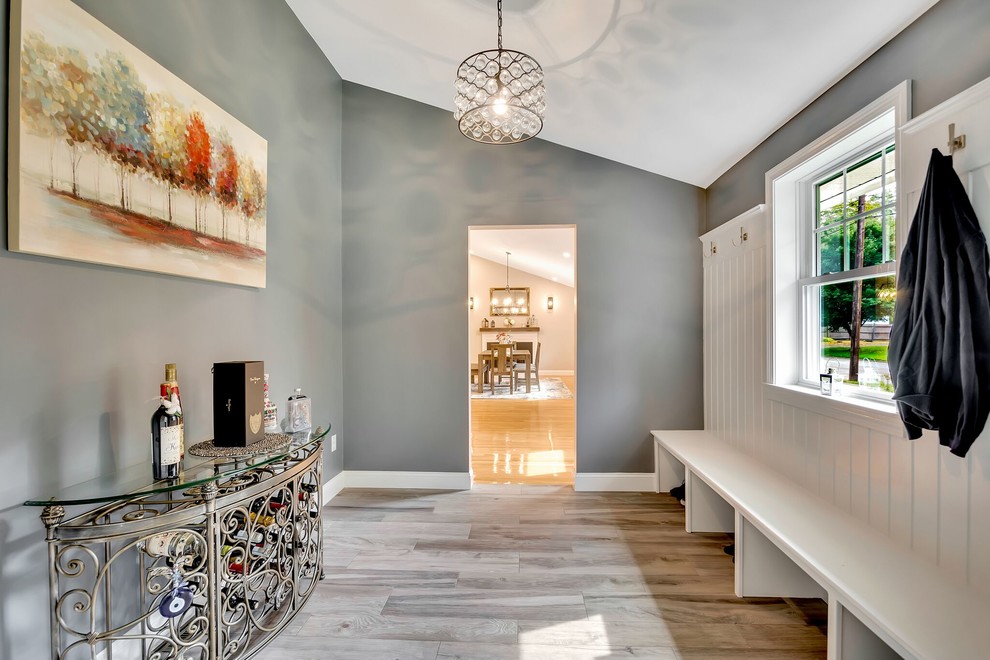 Entry hall - transitional light wood floor and gray floor entry hall idea in Boston with gray walls