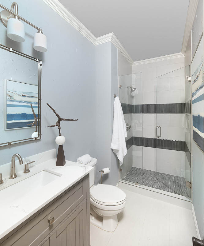 Inspiration for a small coastal shower room bathroom in Dallas with an alcove shower, a one-piece toilet, blue walls, a built-in sink, white floors, a hinged door, white worktops, a single sink and a built in vanity unit.