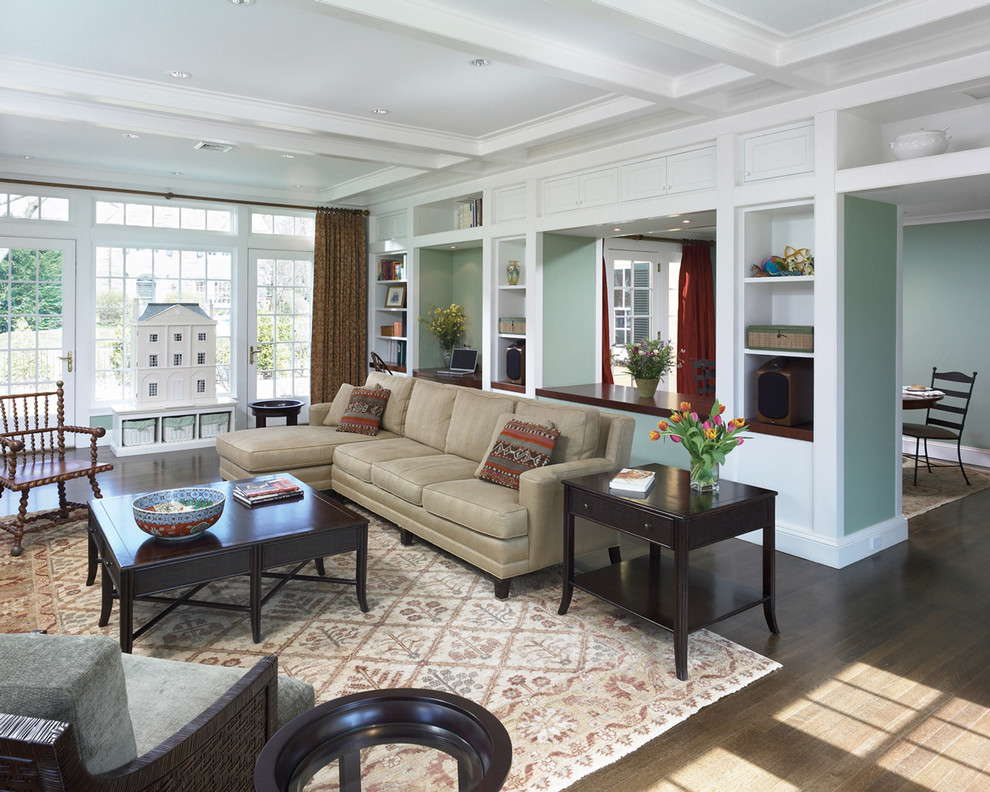 Inspiration for a traditional living room in Philadelphia with green walls and brown floor.