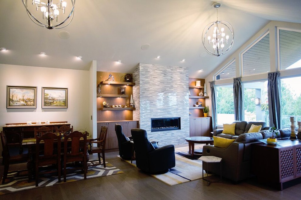 This is an example of an expansive modern formal open concept living room in Vancouver with white walls, light hardwood floors, a two-sided fireplace, a stone fireplace surround and a concealed tv.