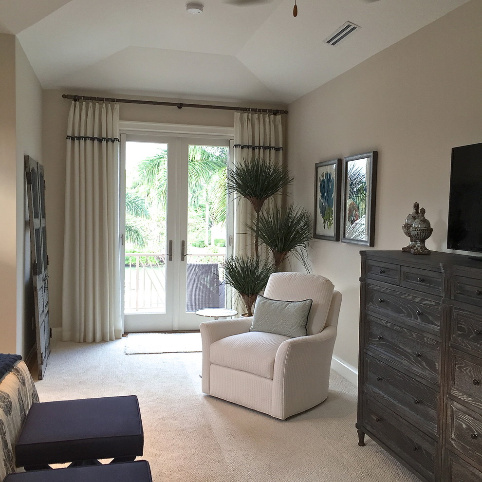 This is an example of a large tropical master bedroom in Miami with beige walls, carpet and white floor.