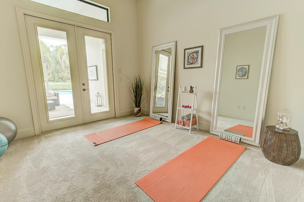 Photo of a mid-sized transitional home yoga studio in Miami with beige walls, carpet and beige floor.