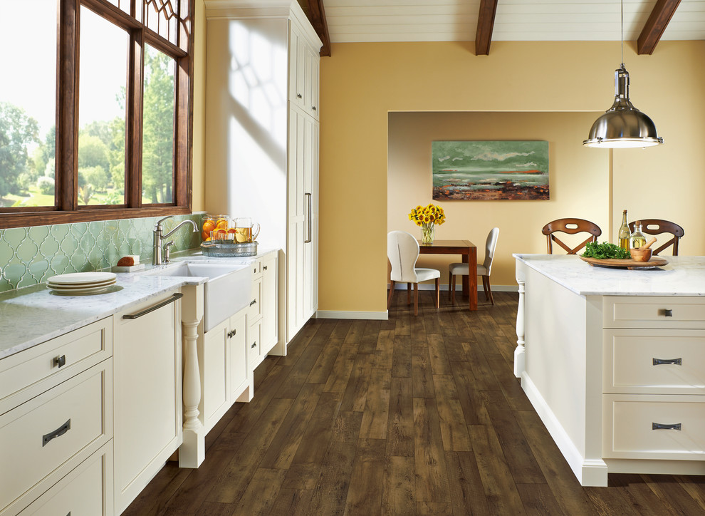 Example of a large transitional l-shaped dark wood floor and brown floor eat-in kitchen design with a farmhouse sink, shaker cabinets, marble countertops, green backsplash, an island, white cabinets, mosaic tile backsplash and white appliances