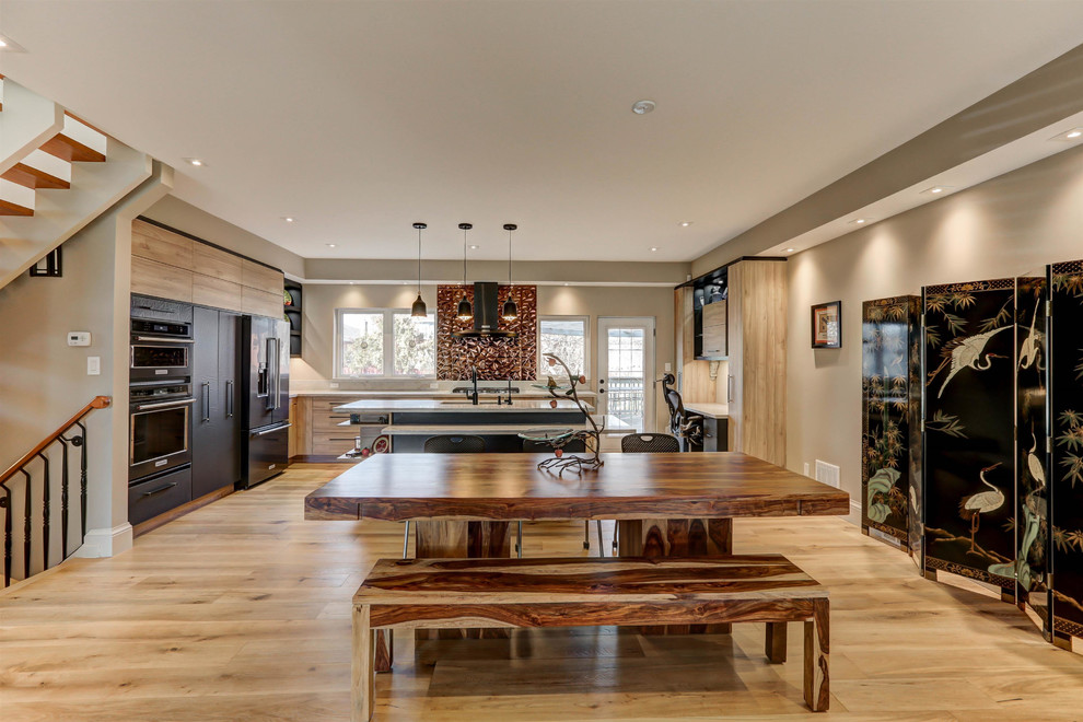 This is an example of a large contemporary open plan dining in Toronto with beige walls, light hardwood floors, no fireplace and brown floor.