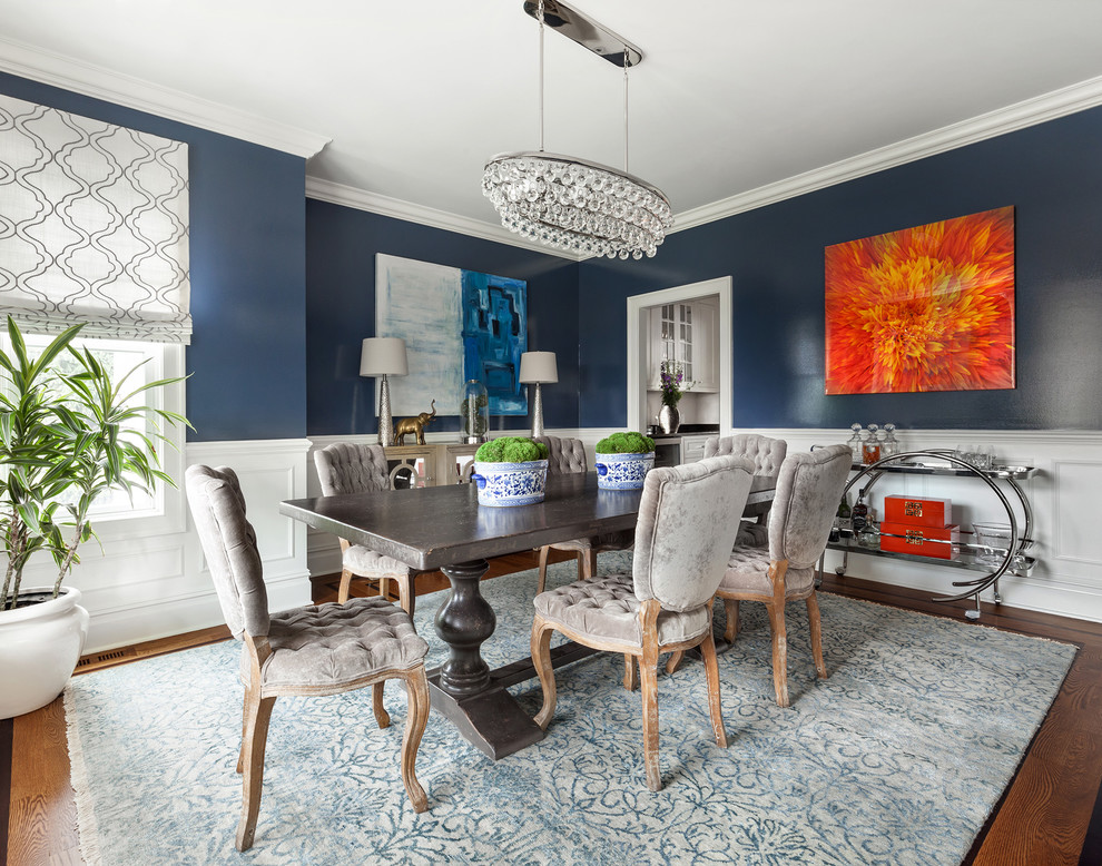 Enclosed dining room - mid-sized transitional medium tone wood floor enclosed dining room idea in New York with blue walls and no fireplace