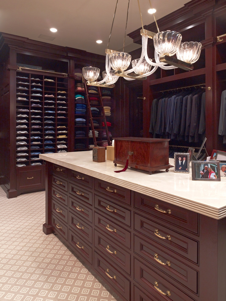 Traditional men's dressing room in Dallas with recessed-panel cabinets, dark wood cabinets and carpet.