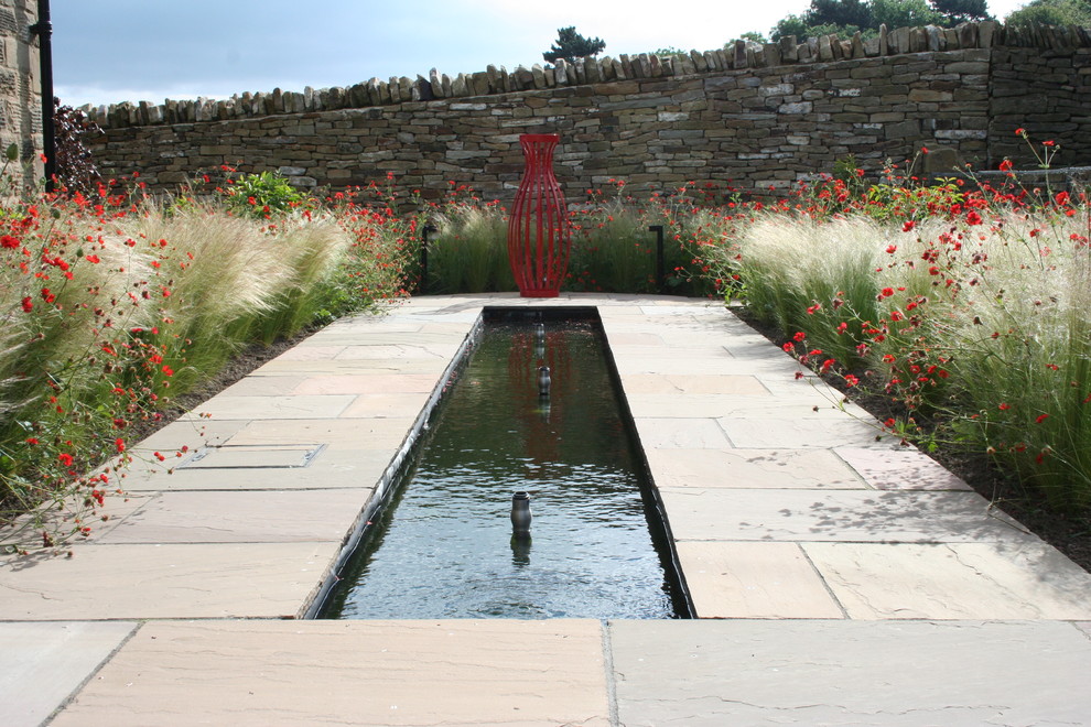 Design ideas for a country garden in Other with a water feature.