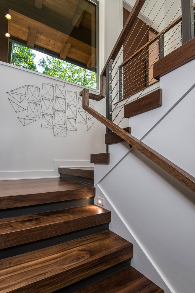 Organic Modern Mountain Home - A striking rustic staircase crafted from reclaimed wood integrates seamlessly with the organic modern design of this sustainable mountain home, reflecting meticulous craftsmanship.
