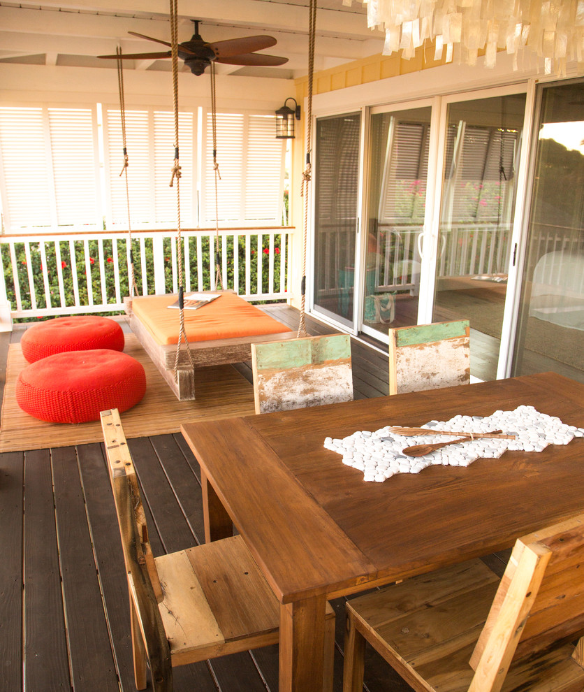 Photo of a mid-sized beach style front yard patio in Hawaii with decking and an awning.