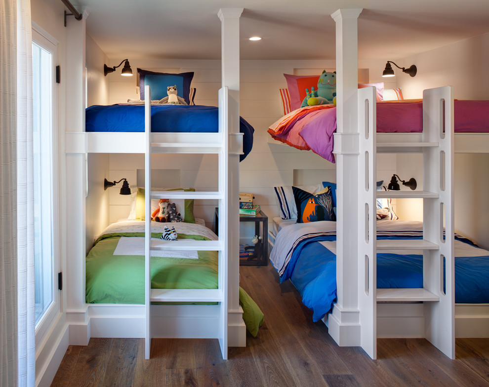 Design ideas for a mid-sized beach style gender-neutral kids' bedroom for kids 4-10 years old in San Diego with white walls and medium hardwood floors.