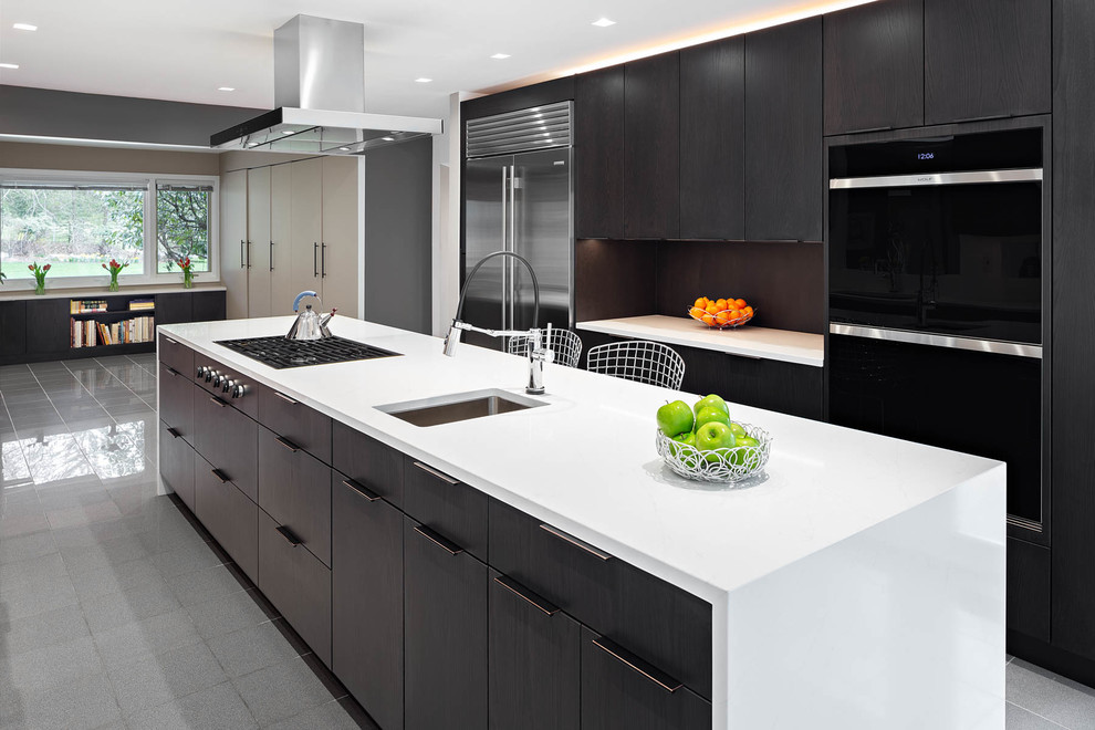 Photo of a large contemporary galley kitchen in Other with an undermount sink, flat-panel cabinets, brown cabinets, brown splashback, stainless steel appliances, with island, grey floor, white benchtop, quartz benchtops and marble floors.