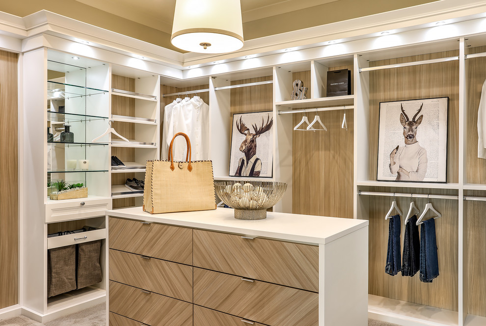 This is an example of a large country gender-neutral walk-in wardrobe in Portland with shaker cabinets, white cabinets, carpet and beige floor.