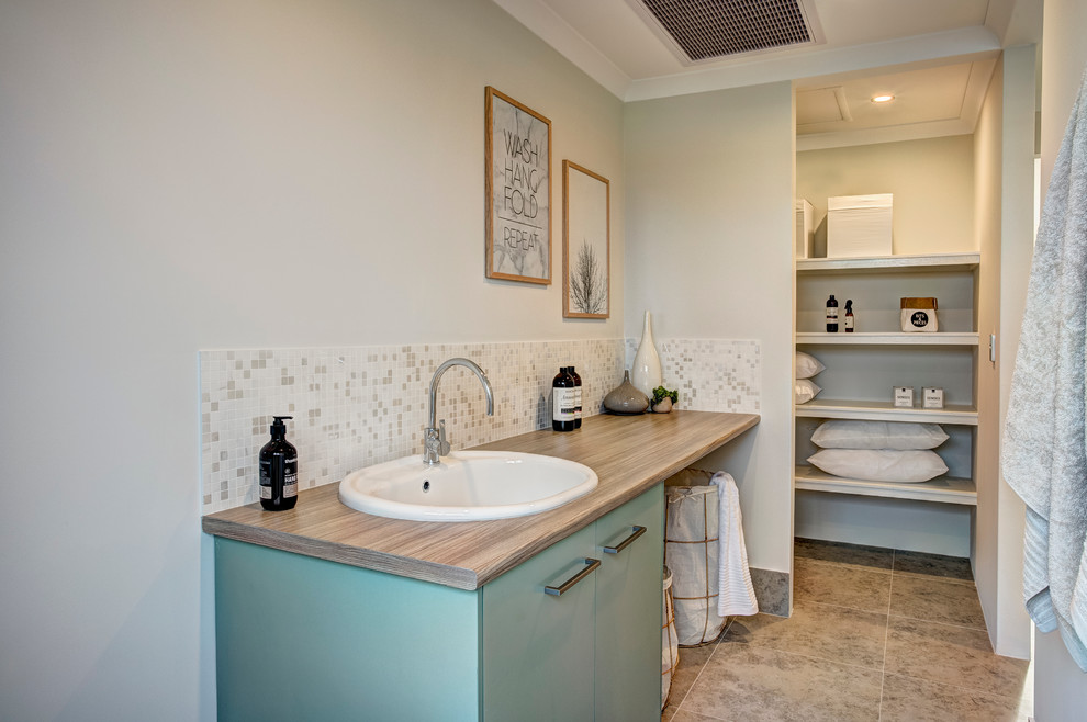 This is an example of a beach style laundry room in Perth.