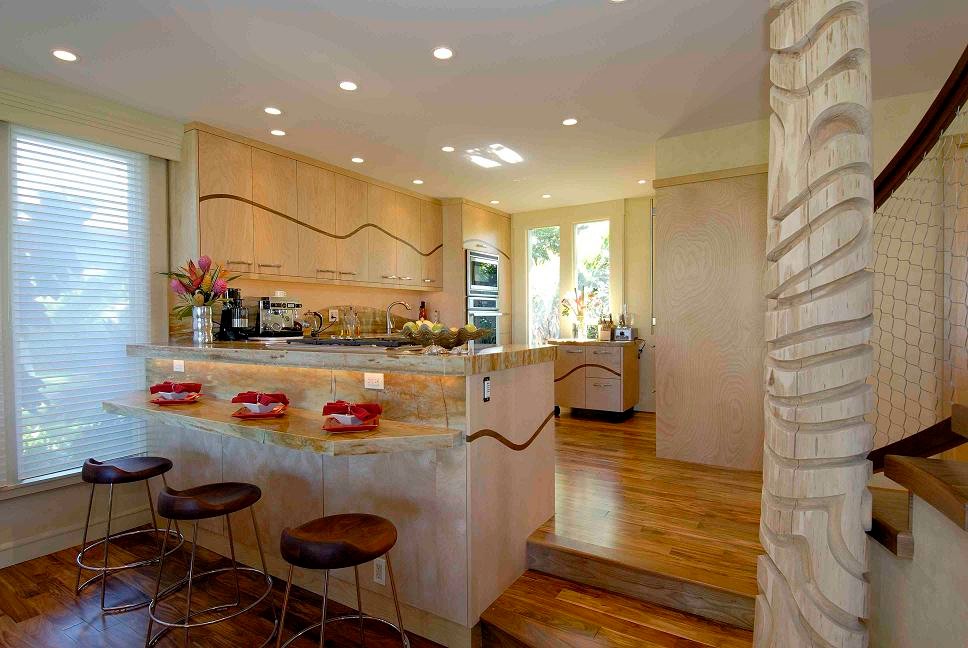 Design ideas for a tropical l-shaped open plan kitchen in Hawaii with an undermount sink, flat-panel cabinets, light wood cabinets, quartzite benchtops, orange splashback, stone slab splashback, stainless steel appliances, medium hardwood floors and with island.