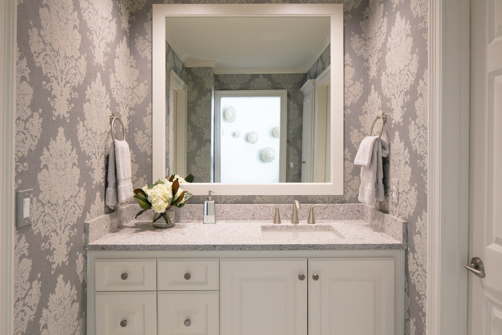 Mid-sized transitional bathroom in Kansas City with white cabinets, a shower/bathtub combo, grey walls, an undermount sink, engineered quartz benchtops, raised-panel cabinets, grey benchtops, porcelain floors and grey floor.