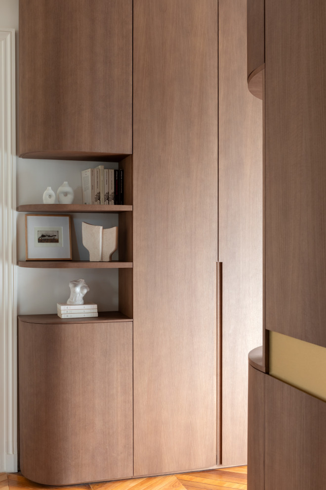 Inspiration for a medium sized classic gender neutral built-in wardrobe in Other with flat-panel cabinets, dark wood cabinets and medium hardwood flooring.