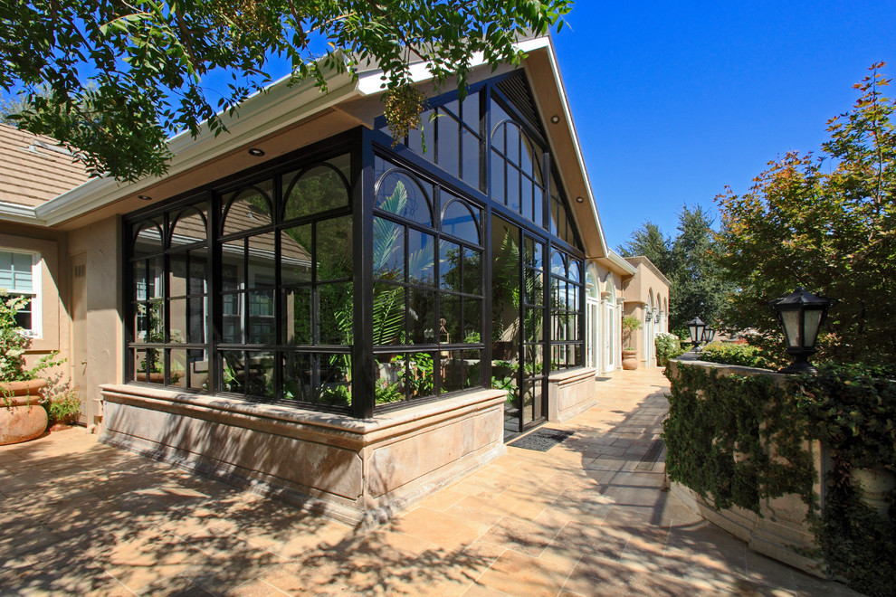 Photo of a mediterranean sunroom in Other with concrete floors.