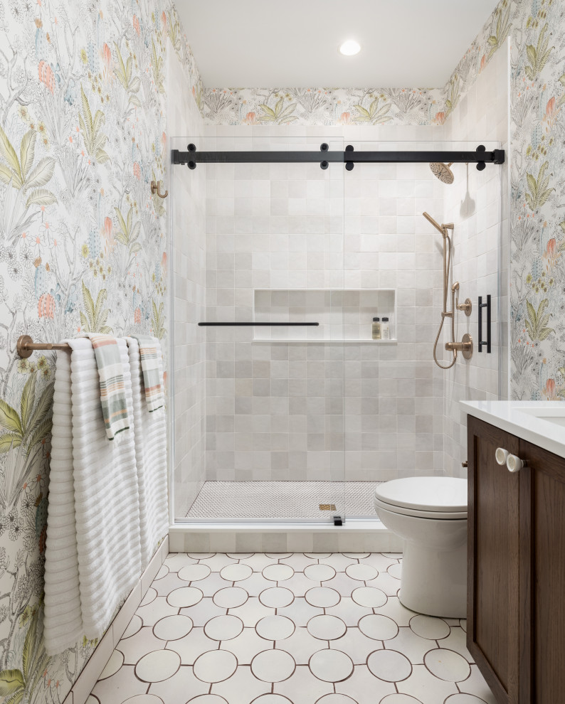 Mid-sized transitional bathroom in Detroit with multi-coloured walls, terra-cotta floors, white floor, a sliding shower screen, white benchtops, a niche, a built-in vanity, wallpaper, shaker cabinets, dark wood cabinets, an alcove shower, white tile and an undermount sink.