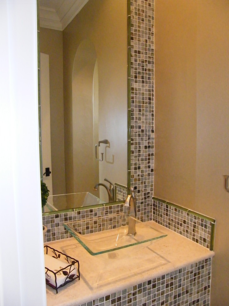 Inspiration for a contemporary powder room in Austin with mosaic tile and a vessel sink.