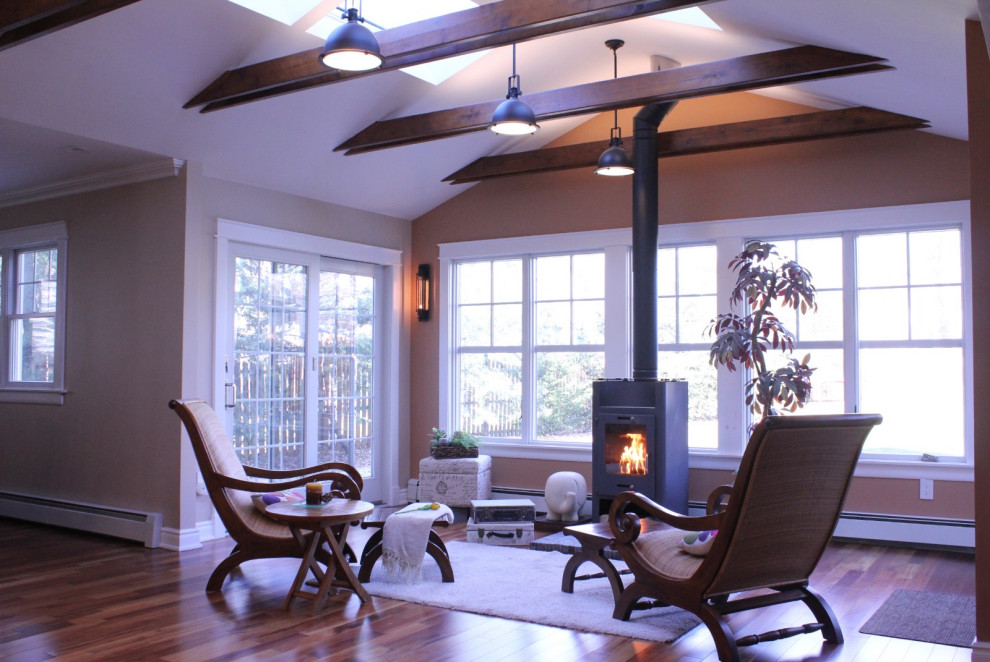 Mid-sized enclosed living room in Boston with dark hardwood floors, a wood stove and vaulted.