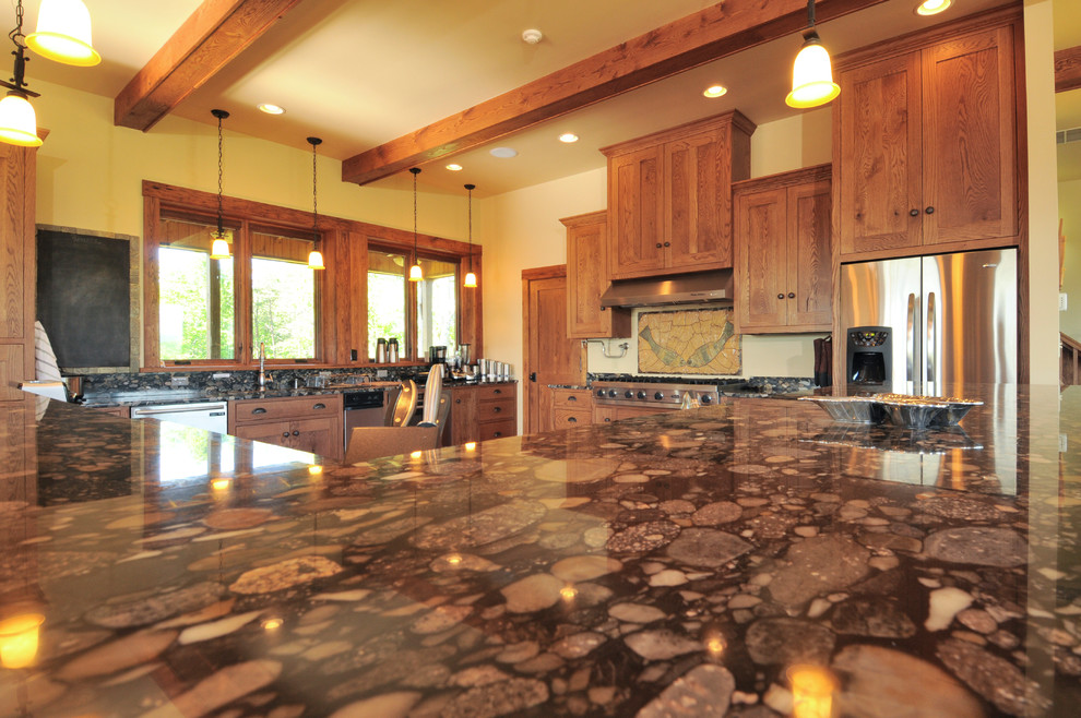 Example of a large mountain style u-shaped medium tone wood floor open concept kitchen design with an undermount sink, shaker cabinets, medium tone wood cabinets, granite countertops and stainless steel appliances