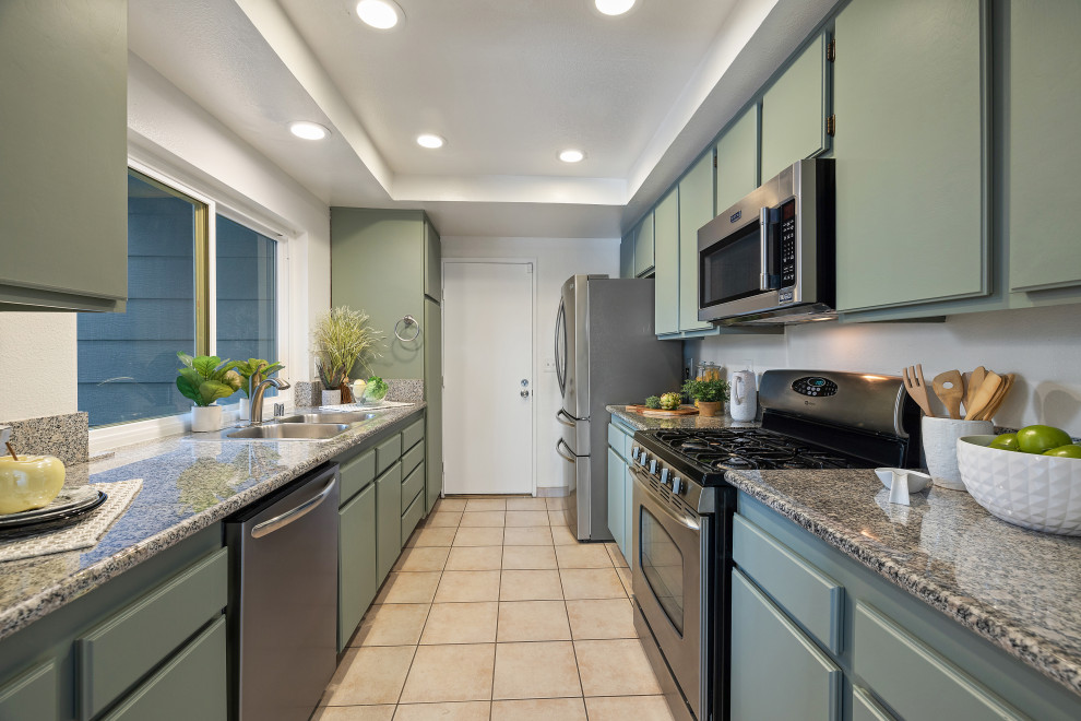 Inspiration for a small transitional separate kitchen in Los Angeles with shaker cabinets, green cabinets, granite benchtops, stainless steel appliances, ceramic floors, beige floor, multi-coloured benchtop and recessed.