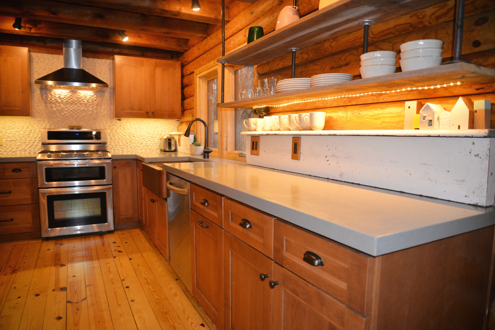 Inspiration for a mid-sized rustic galley light wood floor open concept kitchen remodel in Grand Rapids with an undermount sink, recessed-panel cabinets, medium tone wood cabinets, solid surface countertops, white backsplash, stainless steel appliances and an island